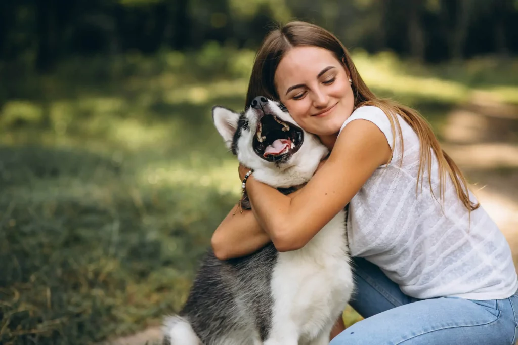 Mulher abrançando seu animal de estimação.